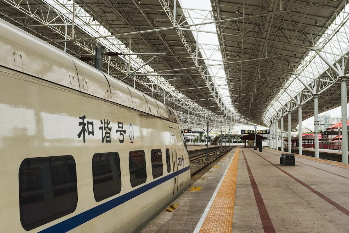 A Chinese high-speed train at a modern station platform in Beijing