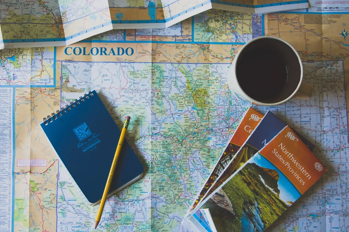 Books, pencil, and coffee cup on a map — planning a trip to China