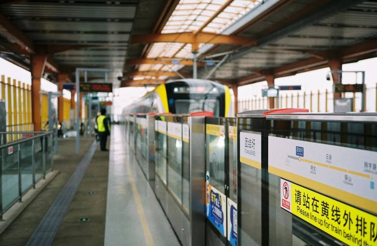 A modern metro train arriving at a station platform in Nanjing