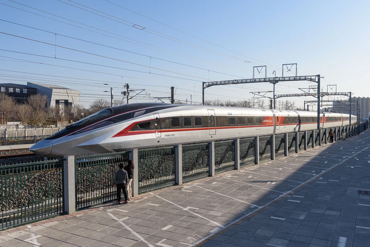 White CR450 high-speed train on a test run across a Chinese plain