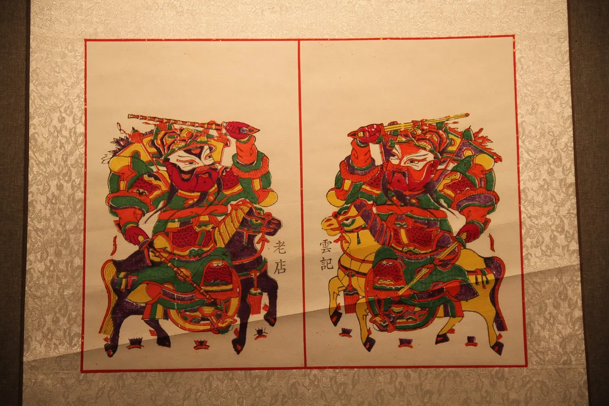 Um par de deuses da porta guerreiros a cavalo, impressos no estilo da cidade de Zhuxian, Qin Qiong à esquerda e Yuchi Gong à direita, em exibição no Museu de Kaifeng (Photo: Gary Todd, CC0)