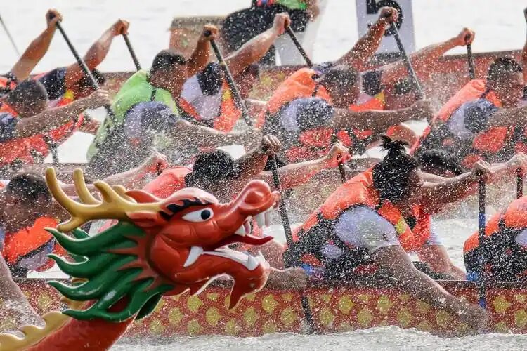 Dragon boats racing on a river during the Dragon Boat Festival in China