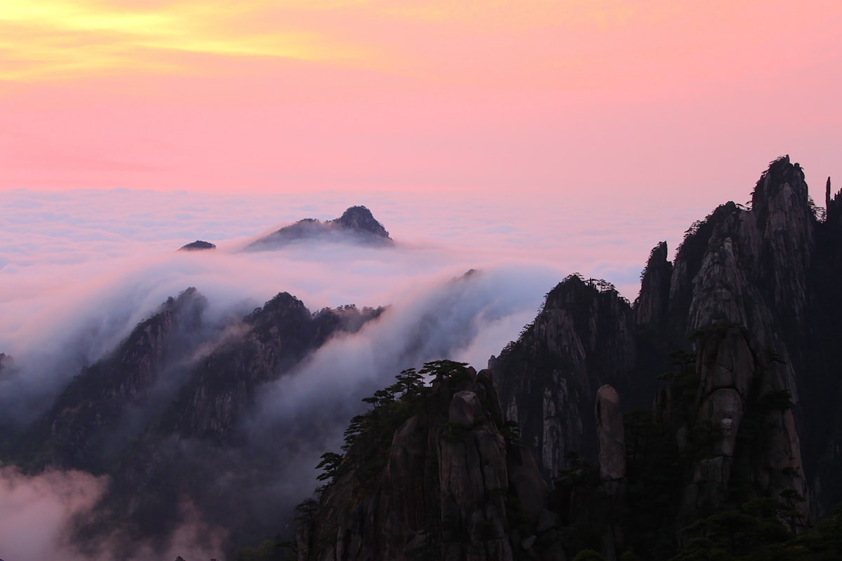 Sea of clouds rolling through granite peaks and twisted pines at Huangshan — China's most painted and photographed mountain