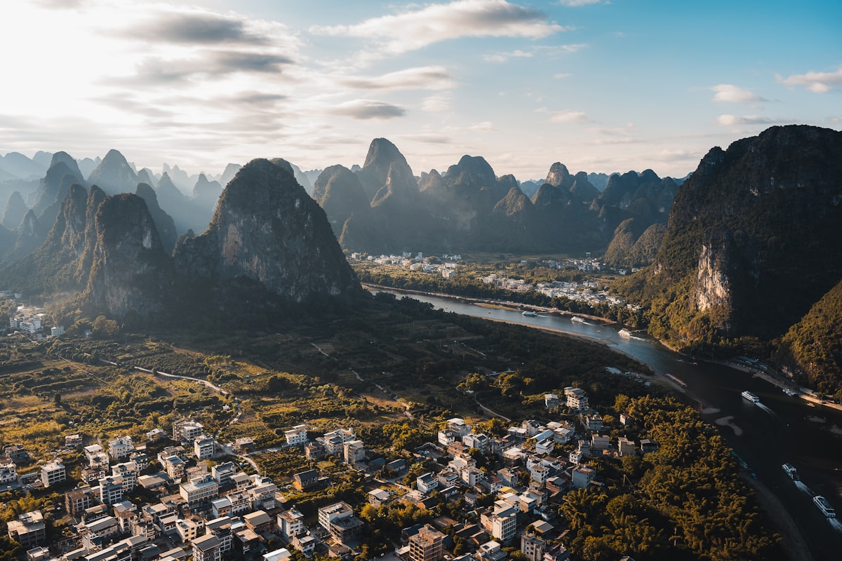Xianggong Mountain sunrise panorama — the Li River S-bend winding through a forest of karst peaks at dawn