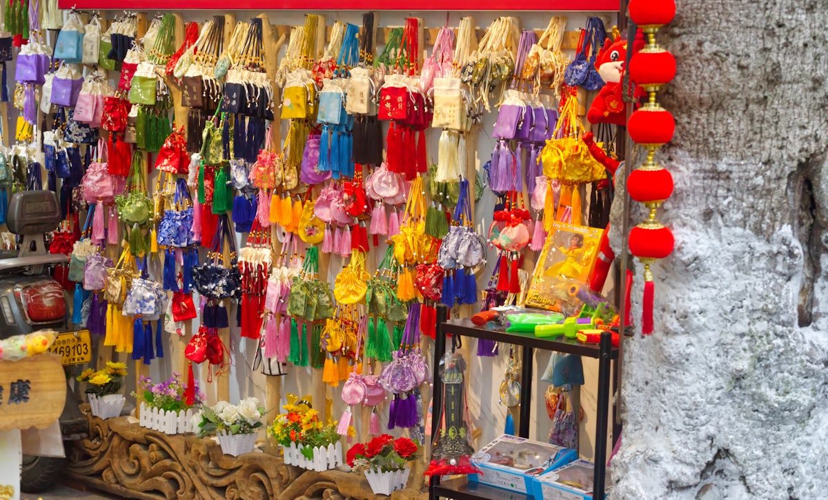 Colorful traditional items and souvenirs hanging on display in a Suzhou shop