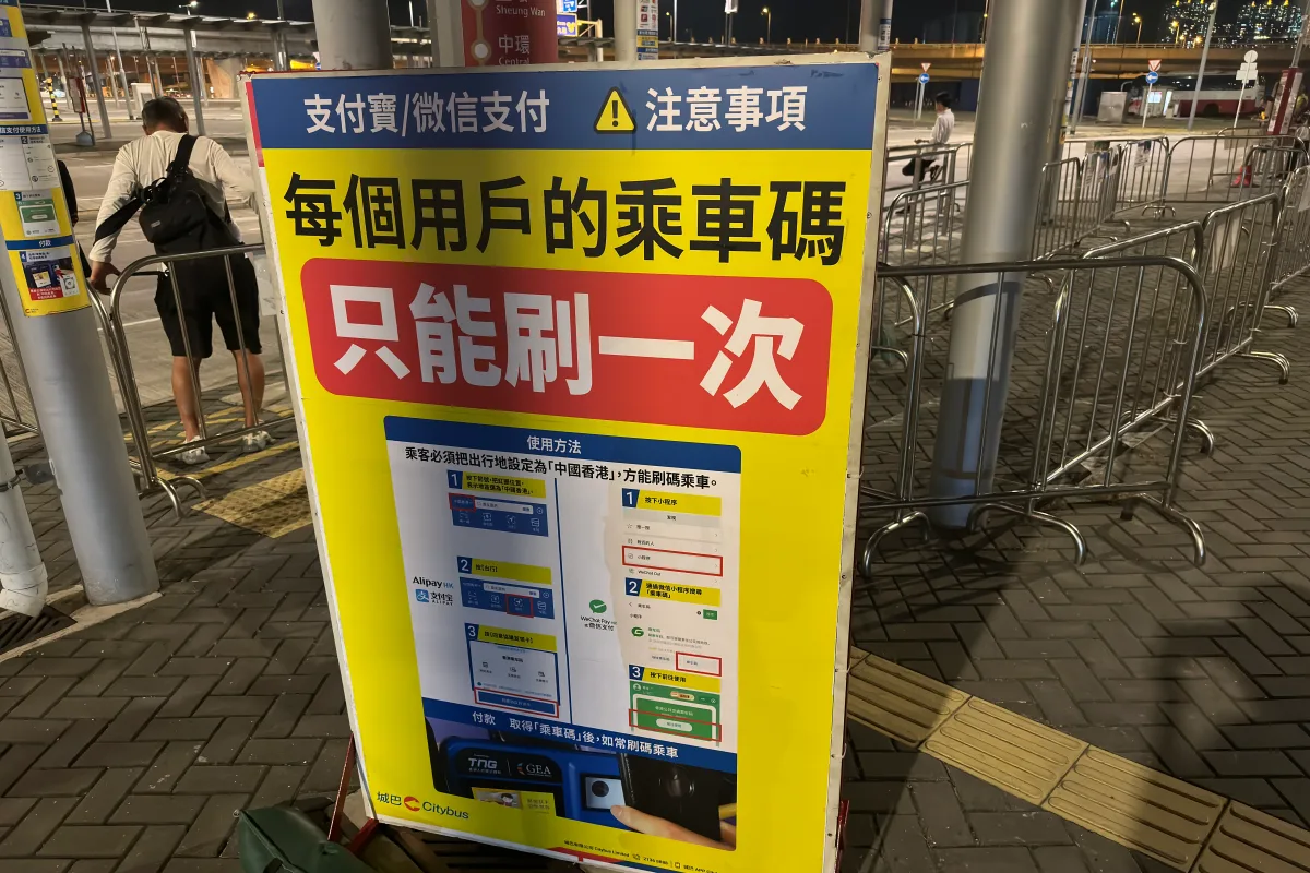 A green WeChat Pay QR code taped to a shop counter in China
