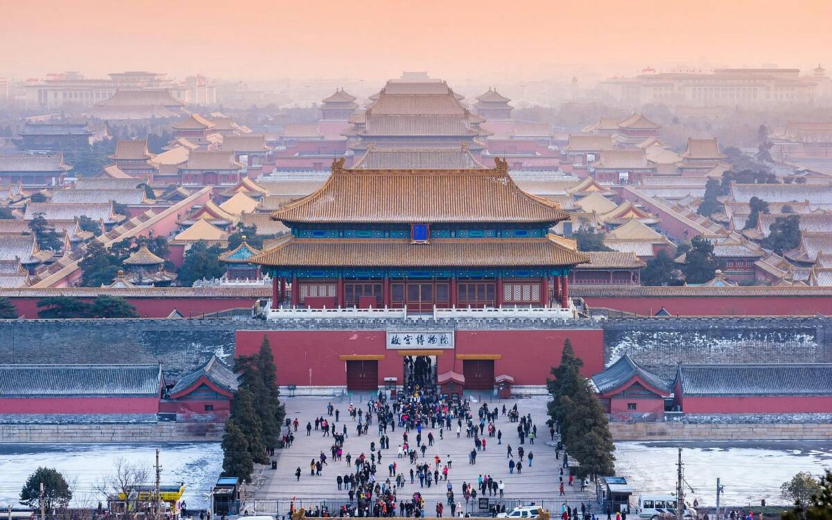 Forbidden City imperial palace roofs against a bright sky