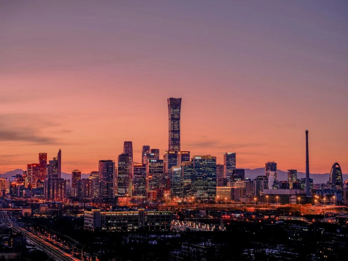Beijing's Guomao CBD skyline at dusk, the China Zun tower rising above the Chaoyang financial district