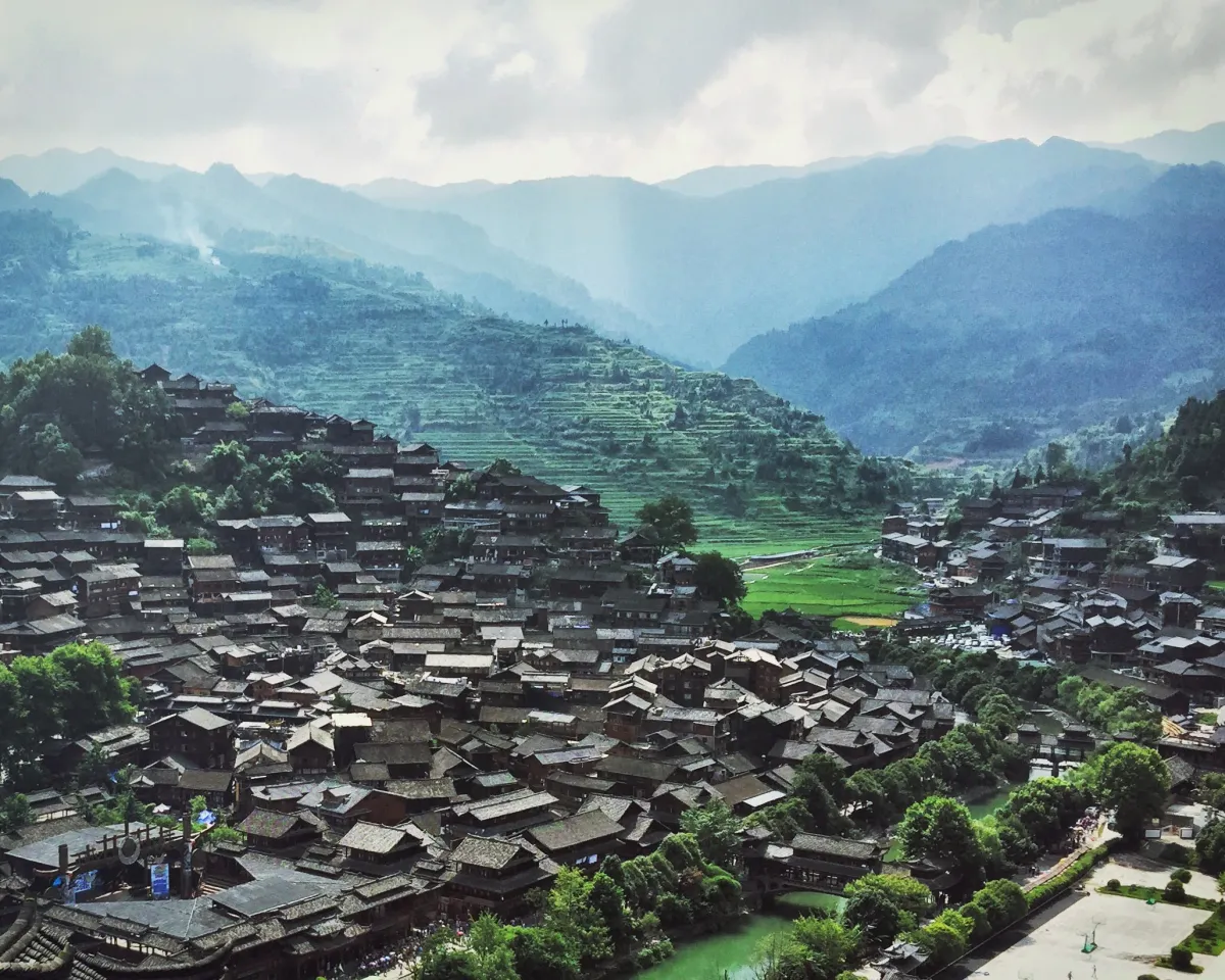 The wooden houses of Xijiang Miao Village stacked up a hillside (Photo: SONG1907 via Wikimedia Commons)