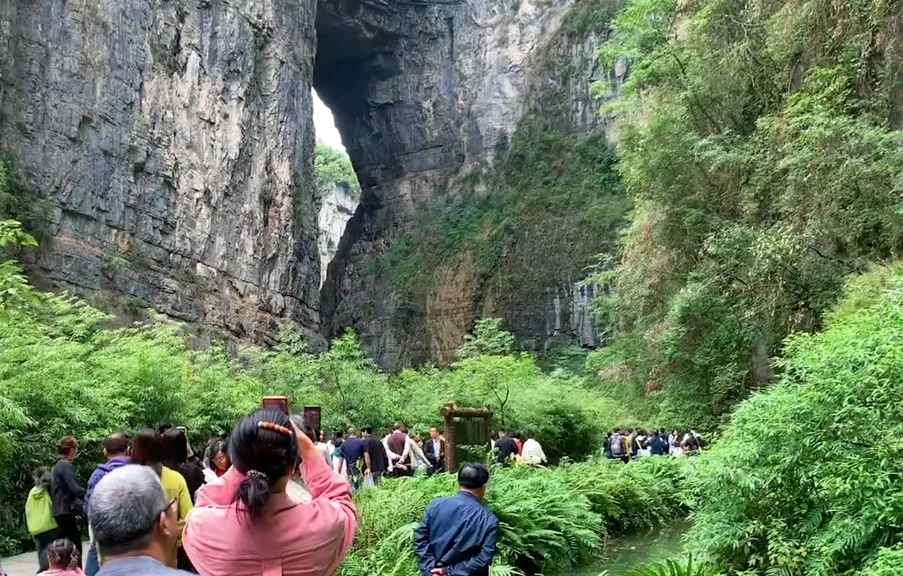The Three Natural Bridges karst arches spanning a misty limestone canyon in Wulong, Chongqing (Photo: China News Service via Wikimedia Commons)