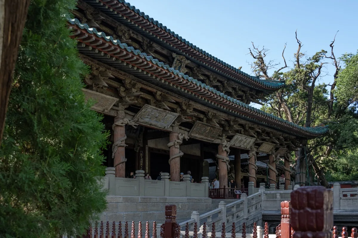 The Holy Mother Hall of Jinci Temple near Taiyuan, a Song dynasty wooden hall with flying eaves and ornate dougong brackets ringed by ancient cypress trees