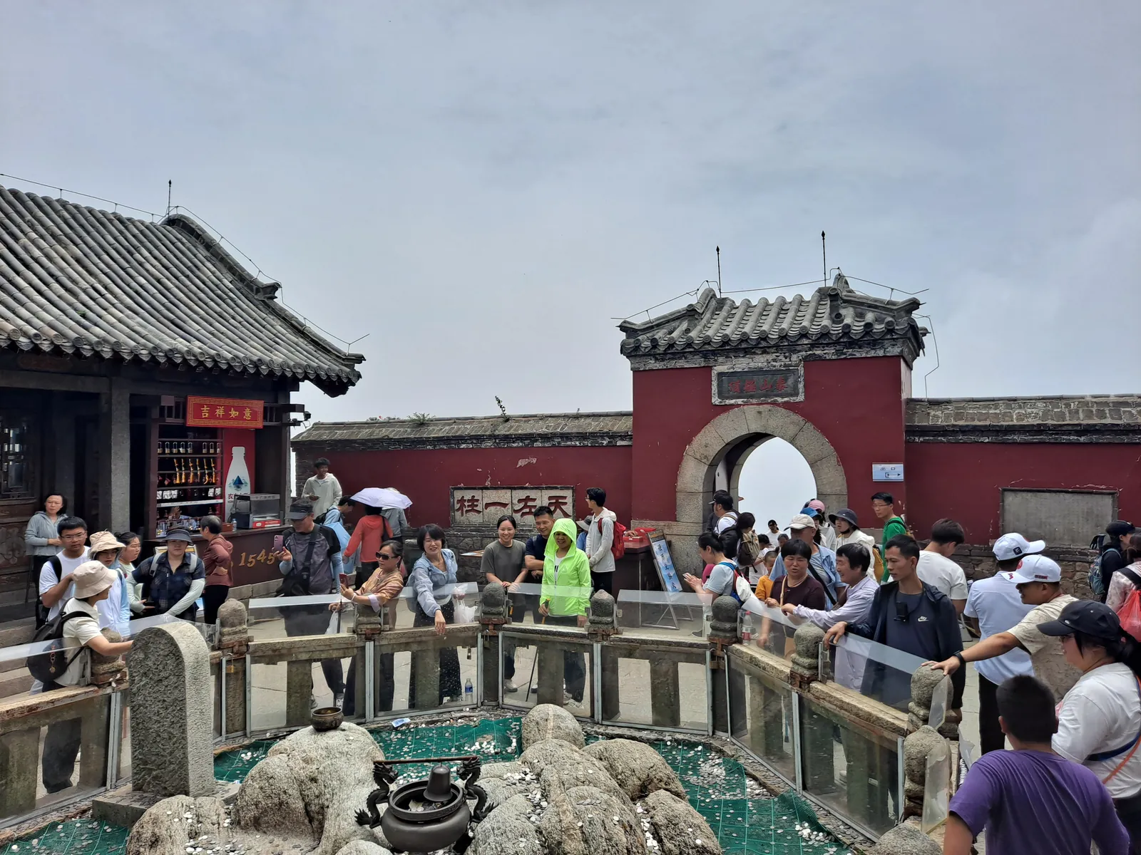 Multitud de visitantes en las rocas bajo el templo y la estación meteorológica del pico del Emperador de Jade, la cima del monte Tai, bajo un cielo azul despejado (Foto: H2v5o68z vía Wikimedia Commons)
