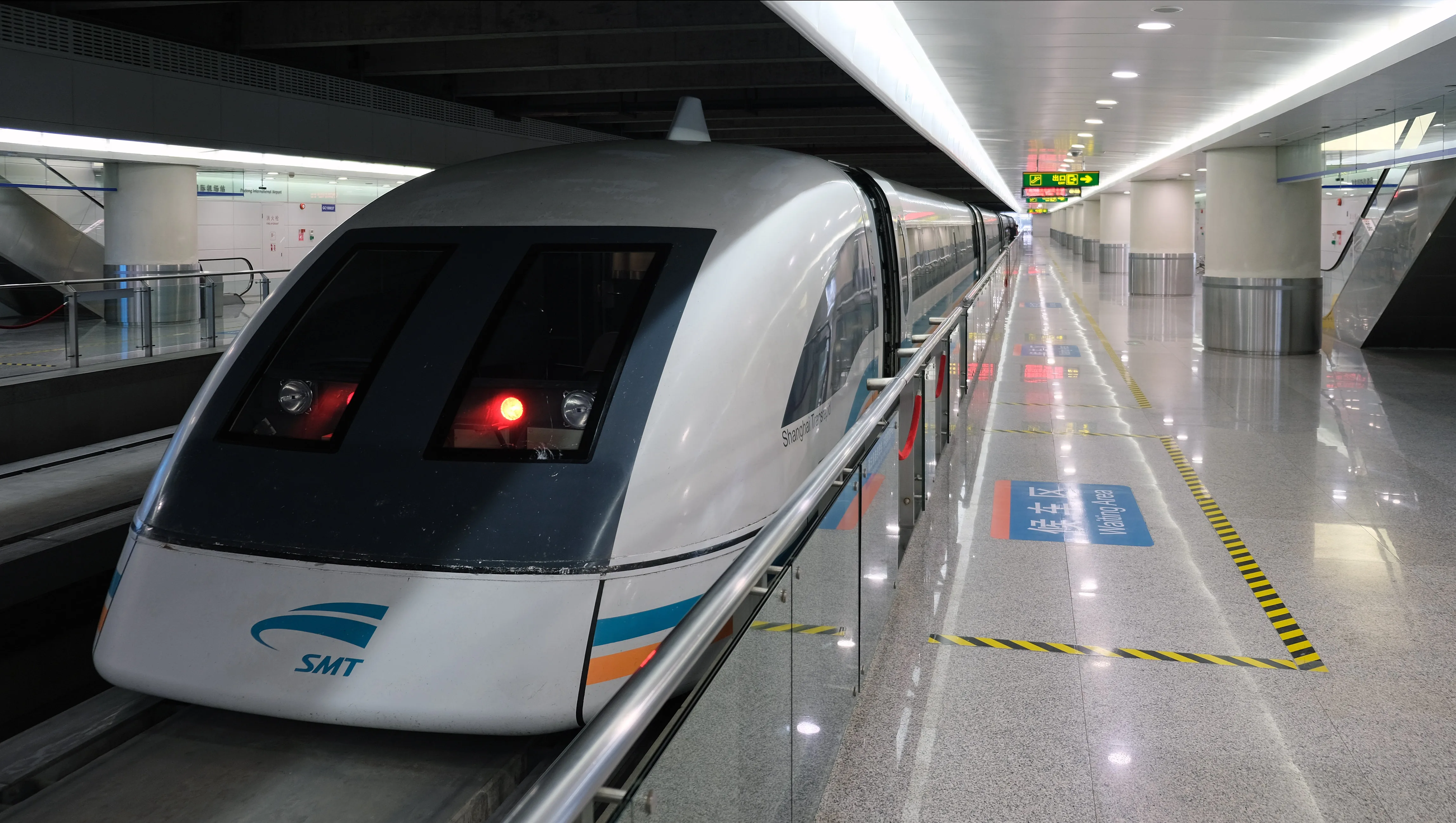 The silver Shanghai Maglev train waiting at Longyang Road station, its SMT branding visible on the nose (Photo: kallerna via Wikimedia Commons)