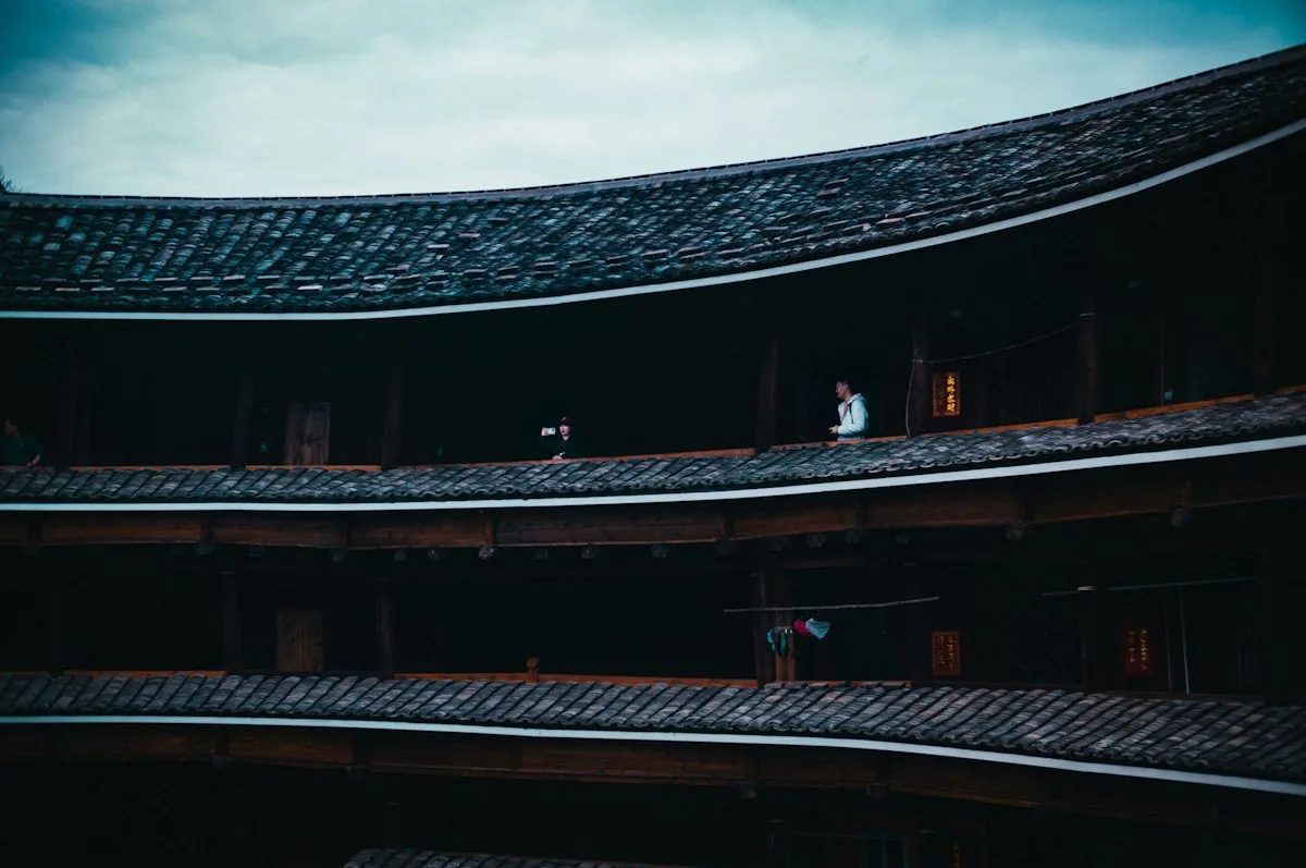 The circular timber galleries inside a Fujian tulou, with guest rooms opening onto each level around the inner courtyard