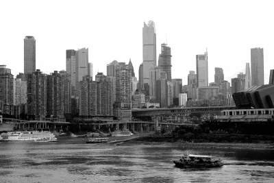 Black and white skyline of Chongqing showing its layered riverfront cityscape