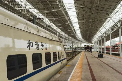 A Chinese high-speed train at a modern station platform in Beijing