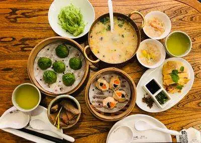 A lively spread of Chinese dishes — dumplings, noodles, stir-fries, and soups representing the diversity of China's Eight Great Cuisines