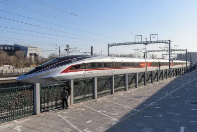 White CR450 high-speed train on a test run across a Chinese plain