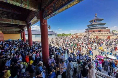 Crowd gathered in front of a large traditional Chinese building during Golden Week