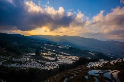 Sunset over terraced rice fields in the mountains of southern China