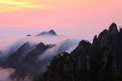Sea of clouds rolling through granite peaks and twisted pines at Huangshan — China's most painted and photographed mountain