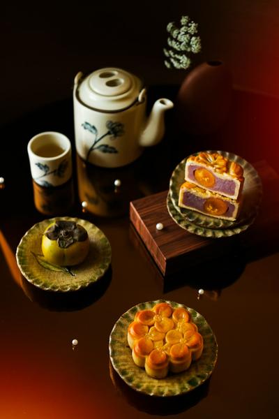 Traditional Chinese mooncakes with tea on a wooden table