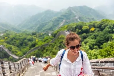 Female solo traveler walking on the Great Wall of China — safe and empowering solo travel in China