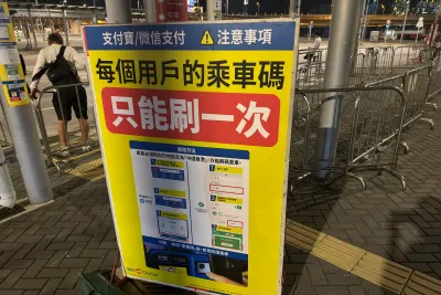 A green WeChat Pay QR code taped to a shop counter in China